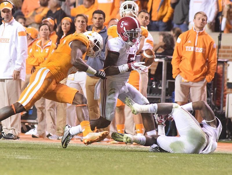 Alabama's Cyrus Jones (5) is forced out-of-bounds by Tennessee's Marquez North (8) after he intercepted a Vol pass in this 2014 file photo.