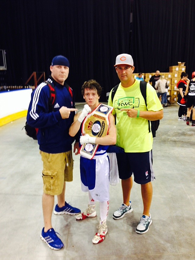 Chattanooga 18-year-old Ringside World champion Slade Corvin stands between Y-CAP coaches Andy Smith, right, and Chad Henley after winning his 108-pound gold medal match Saturday in Independence, Mo. Y-CAP teammate Roger Hilley also won a Ringside gold medal, and volunteer coach Dale Dagnan was a masters runner-up.