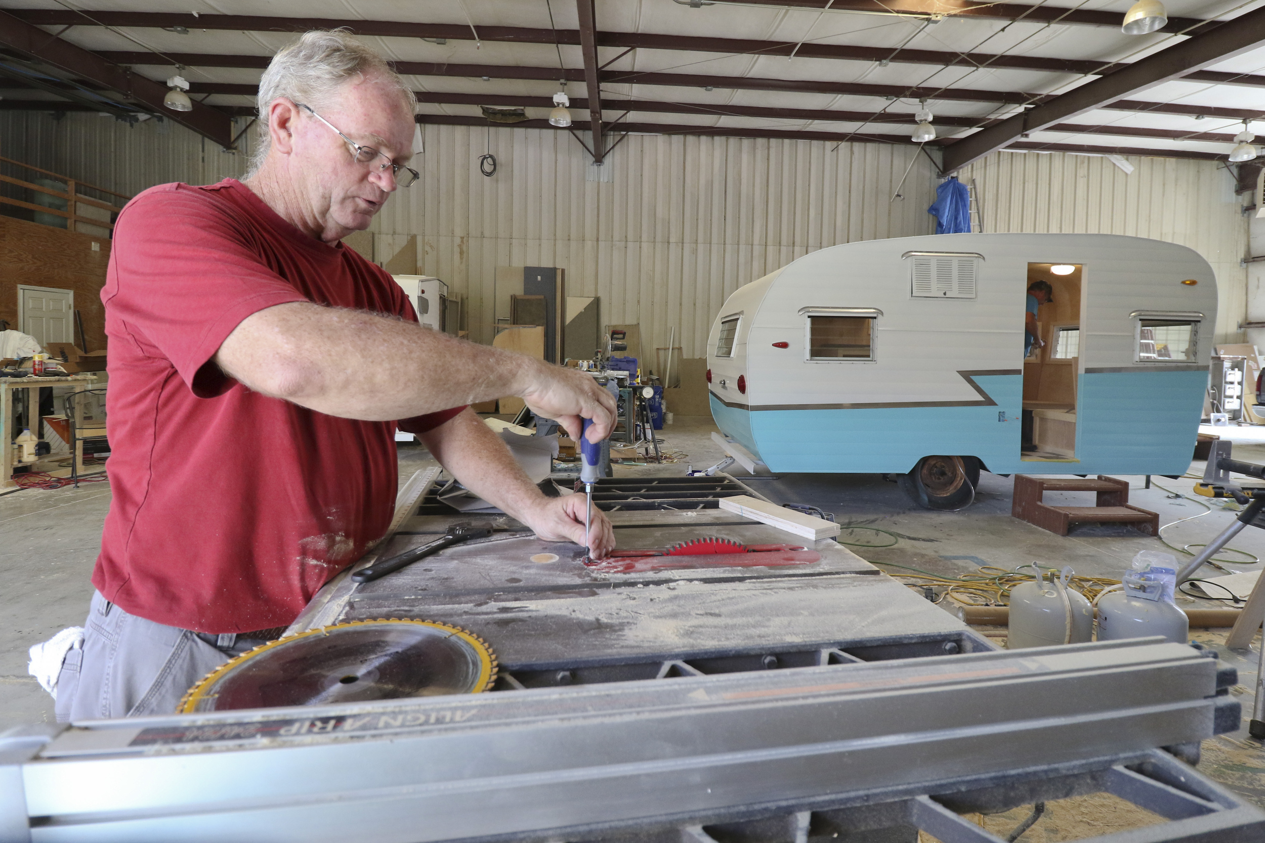 Daryl Bloodworth, left, and his brother Butch Bloodworth, inside trailer, work on renovating a 1961 Shasta Air Flyte while at D.B. Vintage Campers in Rossville, Georgia, on July 30, 2015. The siblings started custom rebuilds of period campers two years ago and have over a dozen to complete on their lot.