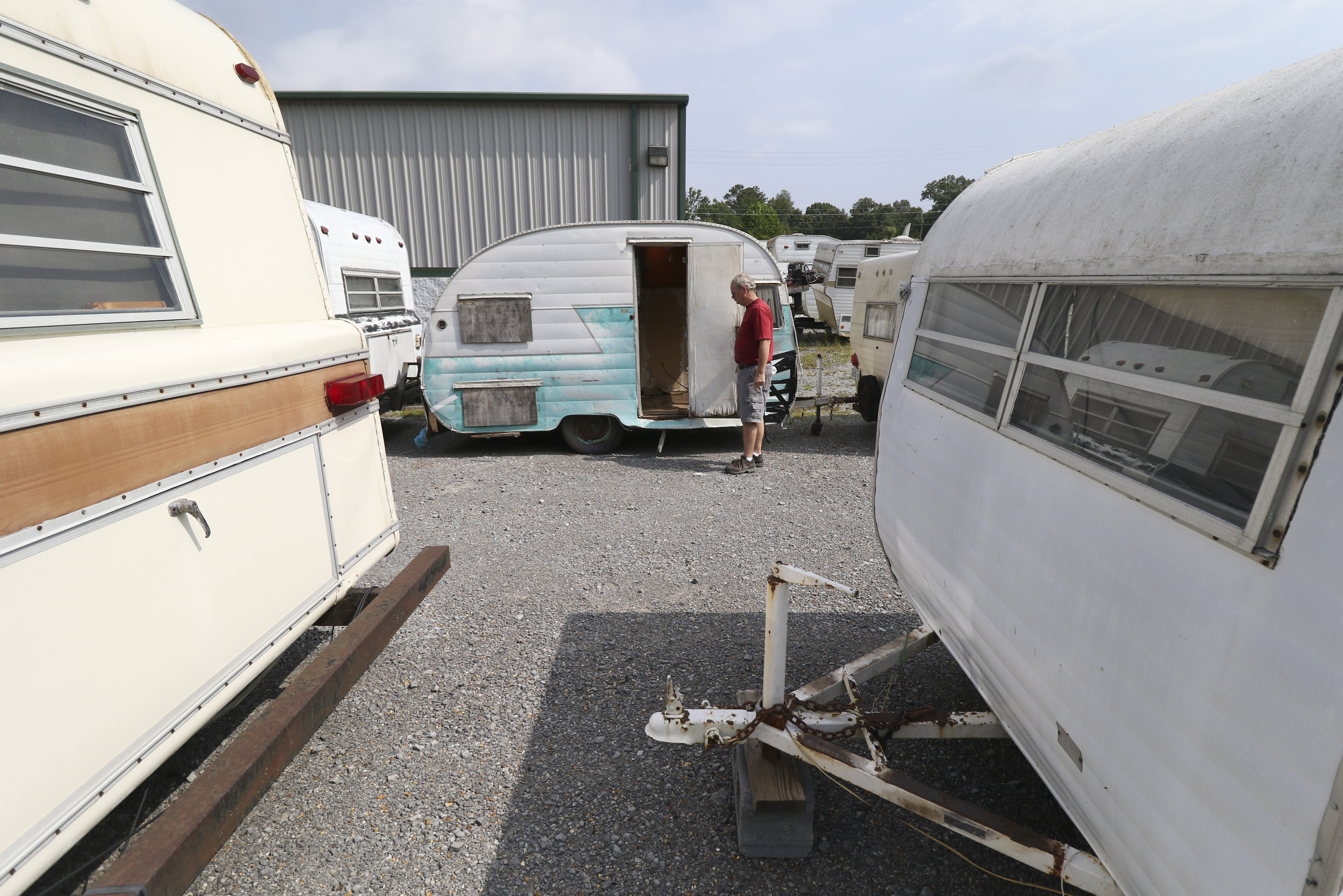 Daryl Bloodworth walks past a "Canned Ham" model Shasta while at D.B. Vintage Campers in Rossville, Georgia, on July 30, 2015.
