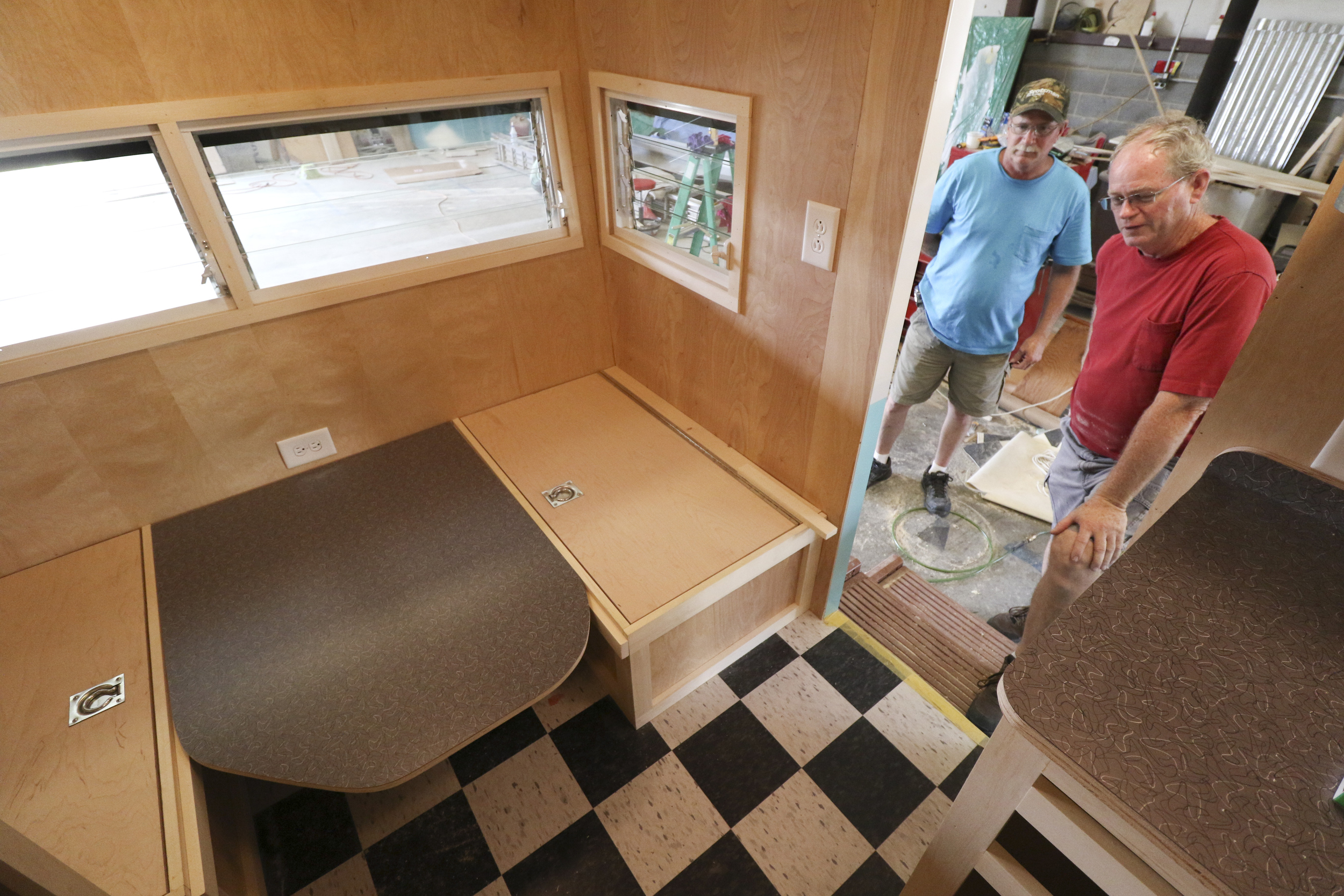 Daryl Bloodworth, right, and his brother Butch Bloodworth work on renovating a 1961 Shasta Air Flyte while at D.B. Vintage Campers in Rossville, Georgia, on July 30, 2015. The siblings started custom rebuilds of period campers two years ago and have over a dozen to complete on their lot.