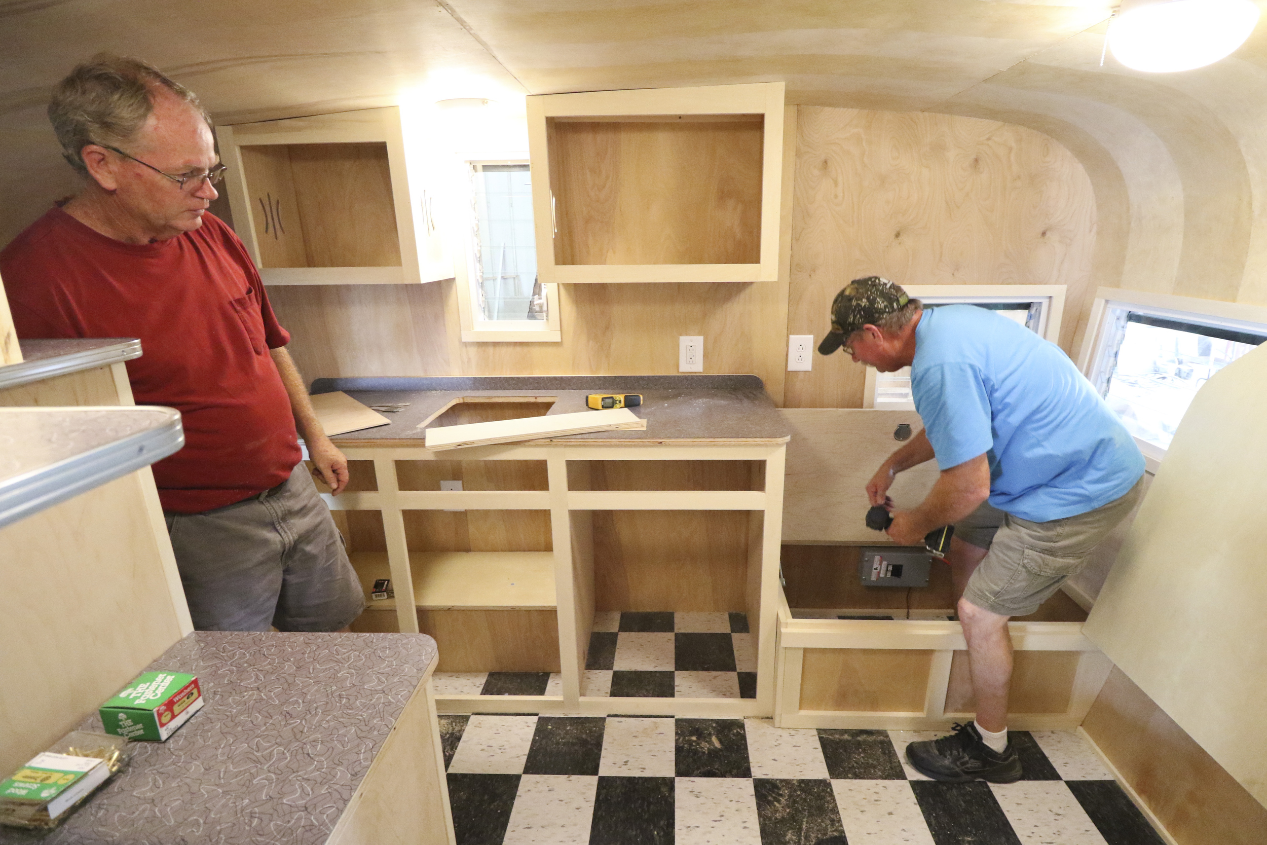 Daryl Bloodworth, left, and his brother Butch Bloodworth work on renovating a 1961 Shasta Air Flyte while at D.B. Vintage Campers in Rossville, Georgia, on July 30, 2015. The siblings started custom rebuilds of period campers two years ago and have over a dozen to complete on their lot.