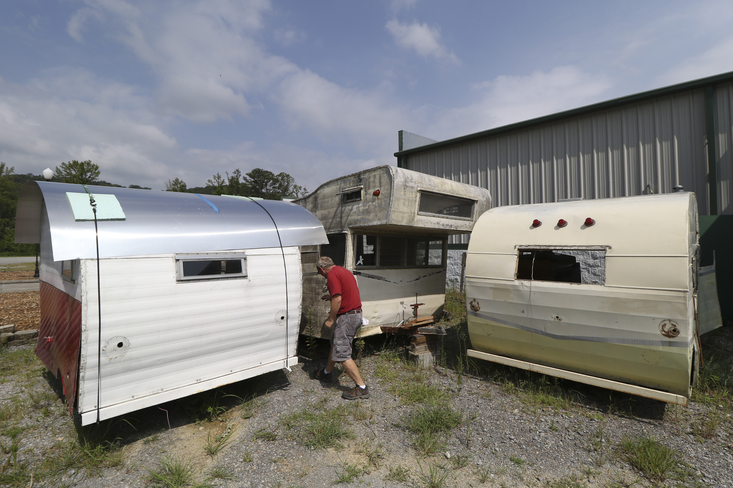 Daryl Bloodworth walks past a couple of "Canned Ham" model Shastas while at D.B. Vintage Campers in Rossville, Georgia, on July 30, 2015.