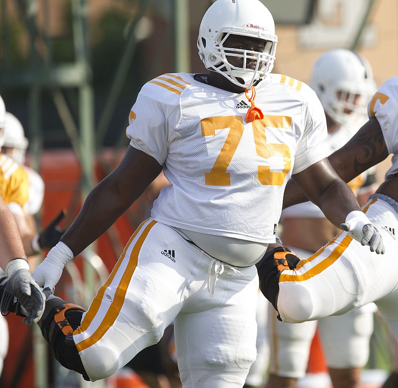 Tennessee Offensive linemen Marcus Jackson, left, and Alex Bullard warm up during an NCAA college football practice at Haslam Field in Knoxville on Saturday, Aug. 10, 2013.