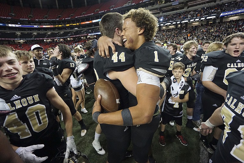 Calhoun's Landon Rice (44) and Kealan Riley (1) celebrate their win over Washington County during the GHSA class AAA championship game at the Georgia Dome in December. The duo lead a strong group of seniors planning for a repeat.