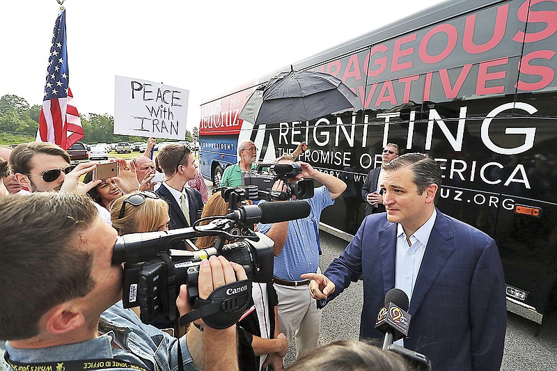 GOP presidential hopeful Ted Cruz, right, speaks to media upon arriving at GraceWorks Church, in Chattanooga, Tenn., on August 10, 2015 during Cruz's first stop on a tour of the state. 