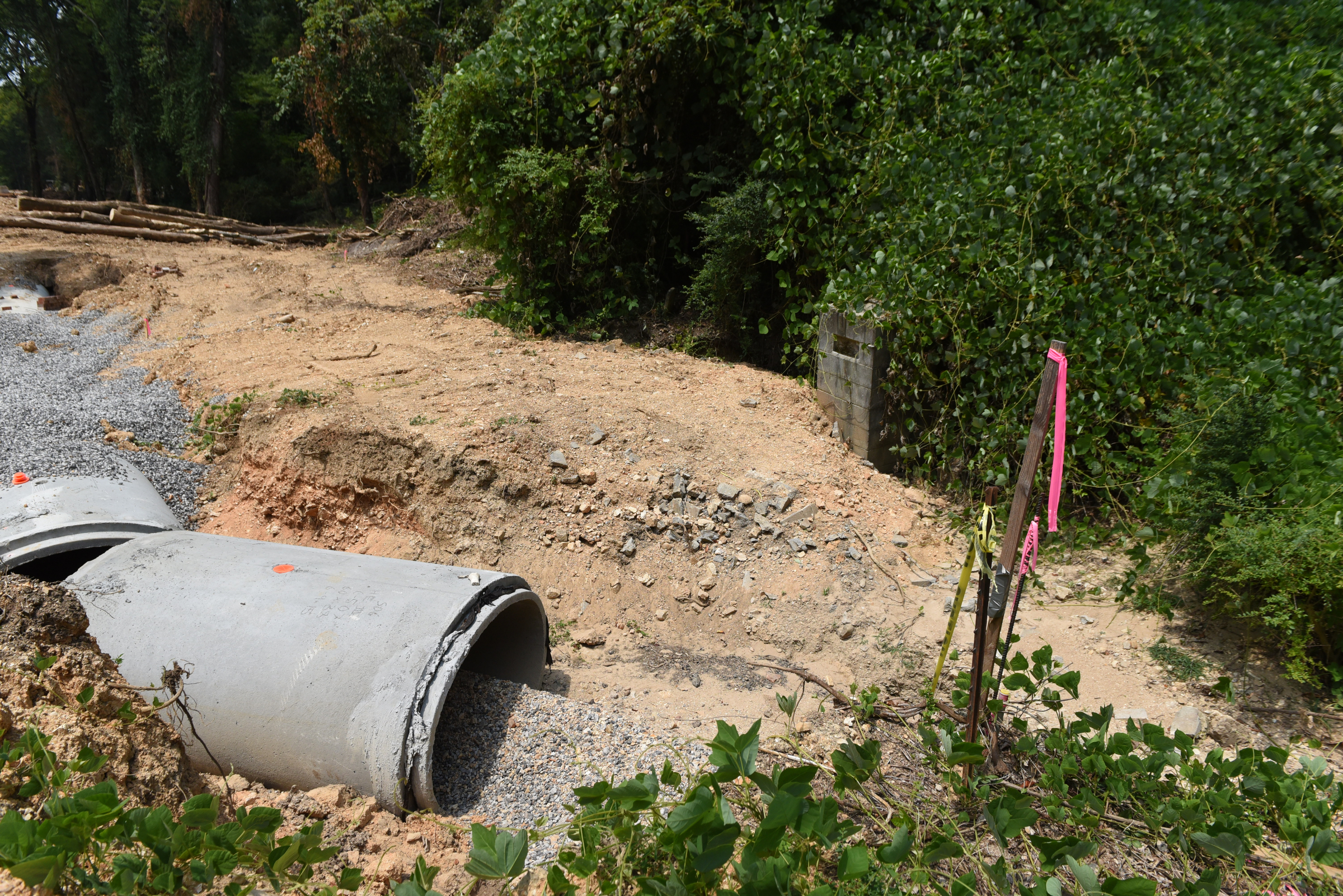 An old cemetery is located next to a construction project on Dartmouth Street in the North Chattanooga community, seen Wednesday, Aug. 5, 2015, in Chattanooga, Tenn. The cinder block structure at the center right is an entrance marker for the cemetery, and an old tombstone is located at the edge of the excavated area.