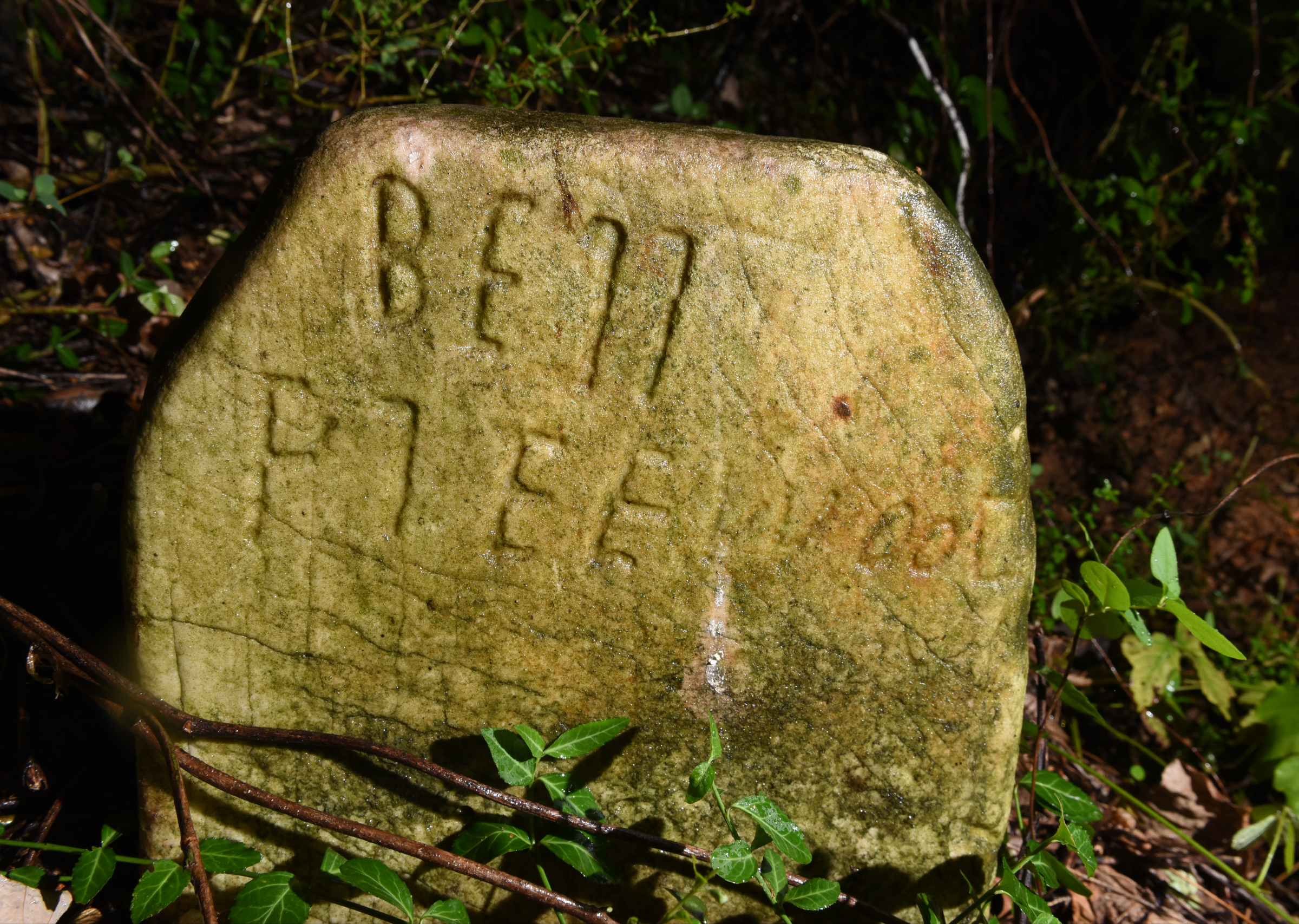 An old tombstone is seen at the site of an old cemetery located next to the construction site for a new housing development on Dartmouth Street in the North Chattanooga community Monday, Aug. 10, 2015, in Chattanooga, Tenn.