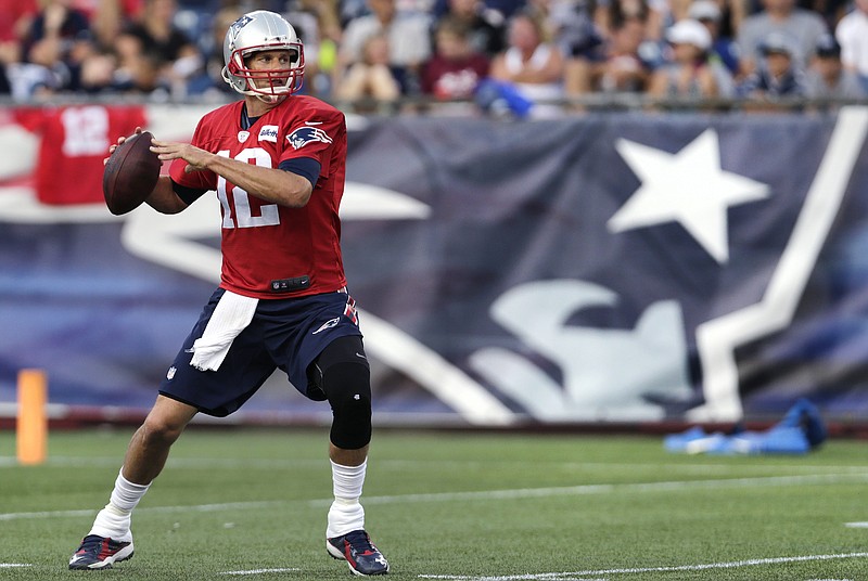 
              New England Patriots quarterback Tom Brady sets to pass during NFL football training camp in Foxborough, Mass., Wednesday, Aug. 5, 2015. (AP Photo/Charles Krupa)
            