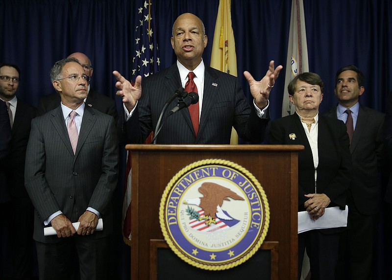 United States Secretary of Homeland Security Jeh Johnson, center, speaks during a news conference in Newark, N.J., Tuesday, Aug. 11, 2015.