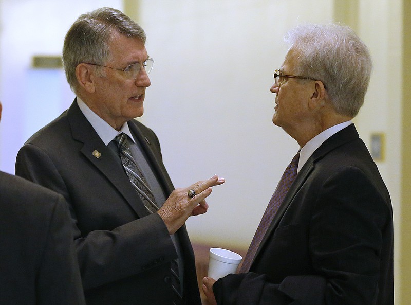 In this Feb. 23, 2015, file photo, Oklahoma state Rep. Gary Banz, left, R-Midwest City, talks with former U.S. Sen. Tom Coburn following a meeting at the state Capitol in Oklahoma City.