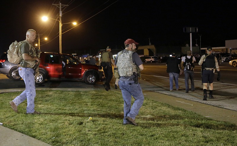 Heavily armed civilians with a group known as the Oath Keepers arrive in Ferguson, Mo., early Tuesday, Aug. 11, 2015.