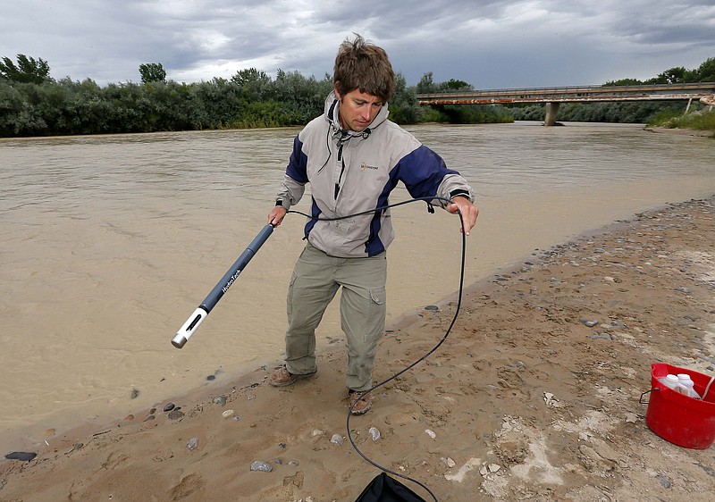 Ben Brown, with the Utah Department of Environmental Quality, takes a pH level reading from a probe in the San Juan River, Tuesday, Aug. 11, 2015, in Montezuma Creek, Utah. A spill containing lead and arsenic from the abandoned Gold King Mine in Silverton, Colo., leaked into the Animas River, which flows into the San Juan River in southern Utah, on Aug. 5. The spill was caused by a mining and safety team working for the EPA.