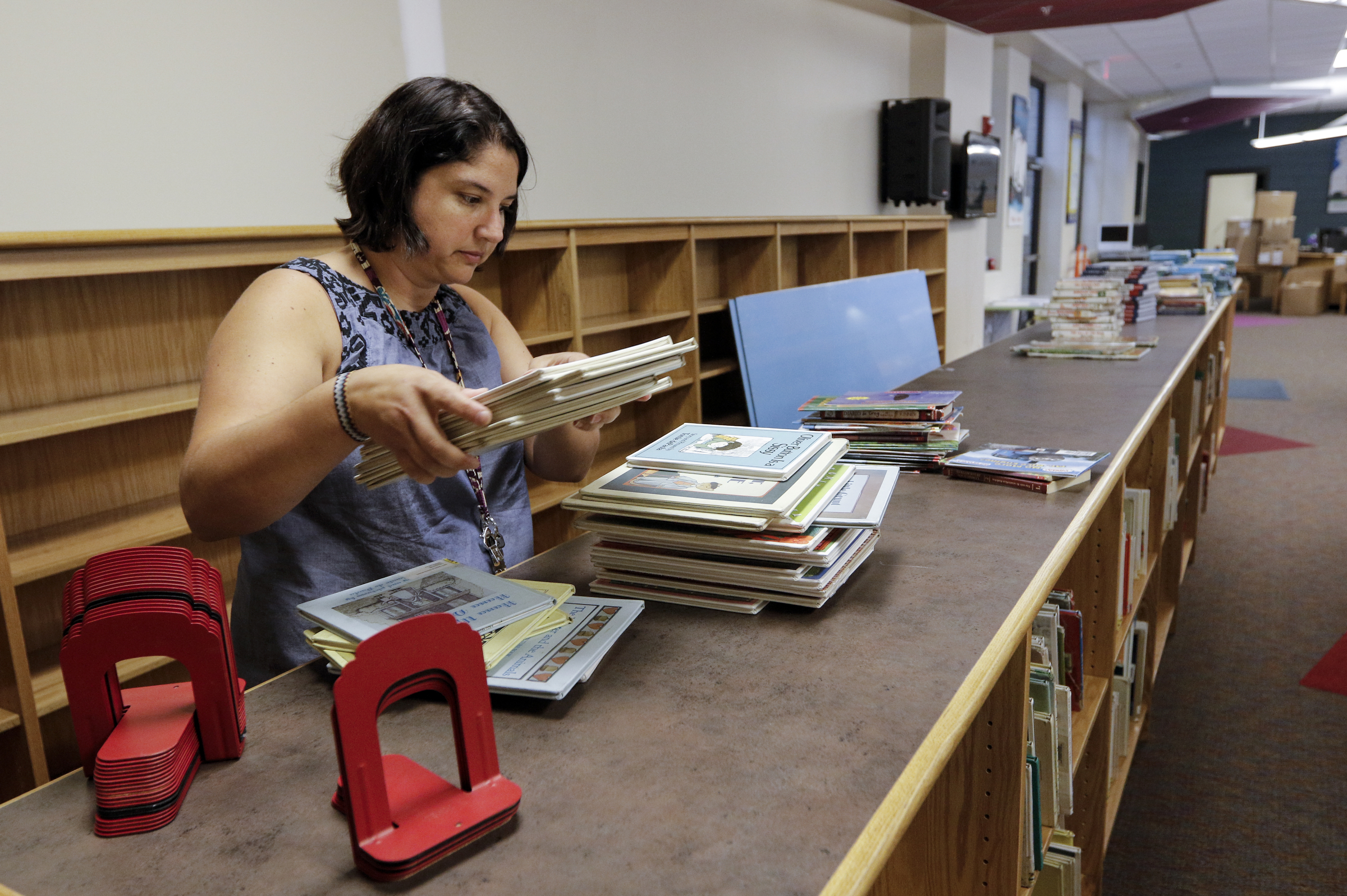 Librarian Nicole Galletta shelves books in the library in preparation for the first day of school Wednesday, Aug. 12, 2015, at the new East Brainerd Elementary School in Chattanooga, Tenn. Thursday is Hamilton County's first day of school.