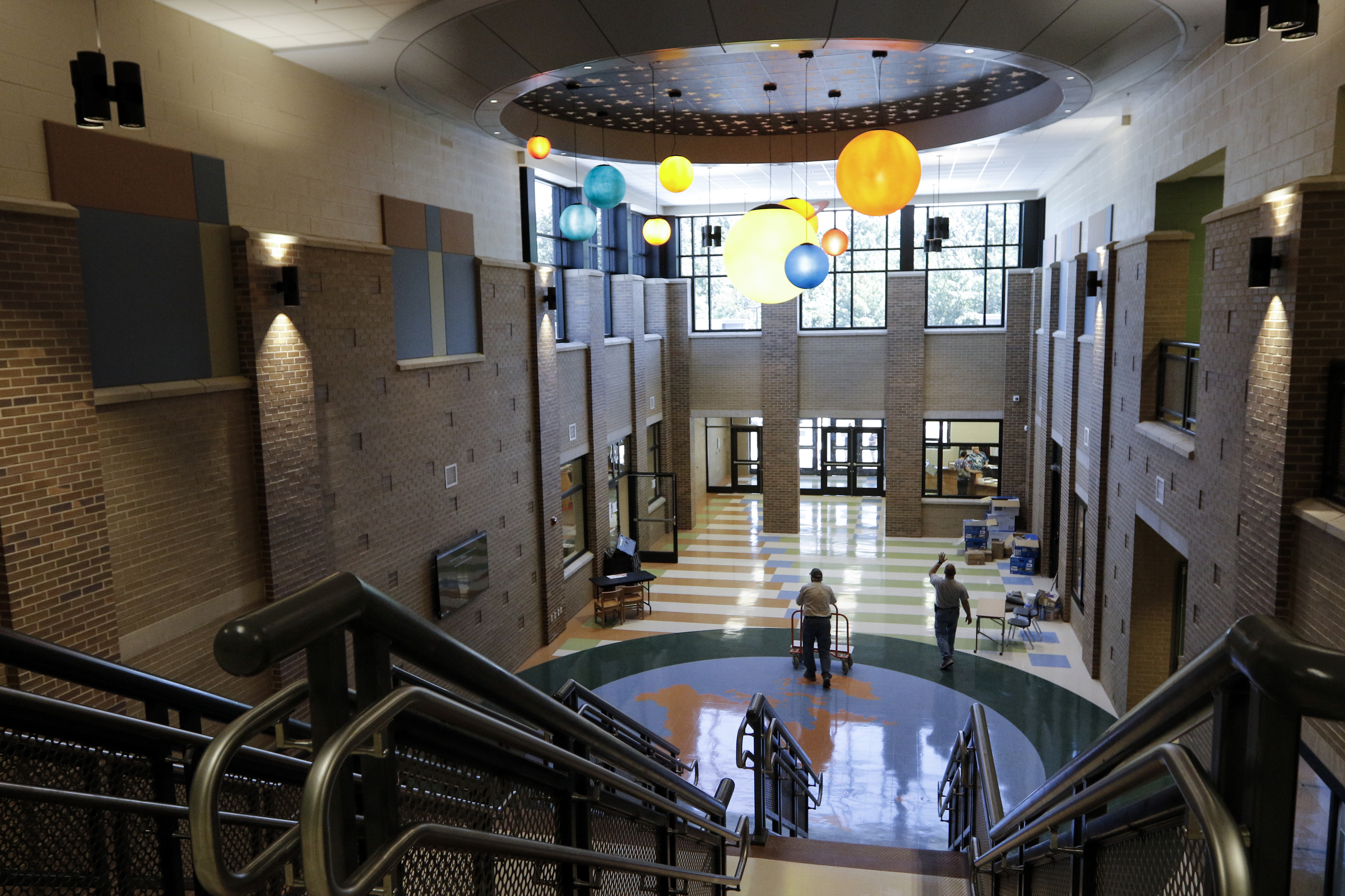 People walk through the atrium Wednesday, Aug. 12, 2015, at the new East Brainerd Elementary School in Chattanooga, Tenn. Thursday is Hamilton County's first day of school.