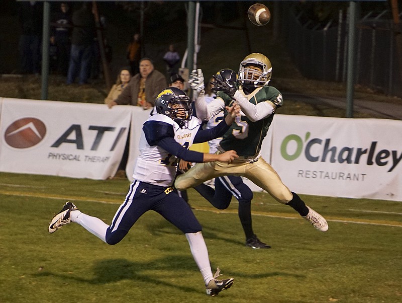 Staff Photo by Dan Henry / The Chattanooga Times Free Press- 11/7/14. Notre Dame's Ricky Ballard (5) reaches for a pass in the end zone as Chattanooga Christian School's Zach Mercer (11) and Ben Moore (24) defend during the first half of the TSSAA Class 3A playoff game Friday, November 7, 2014 at the Fighting Irish’s home field. 