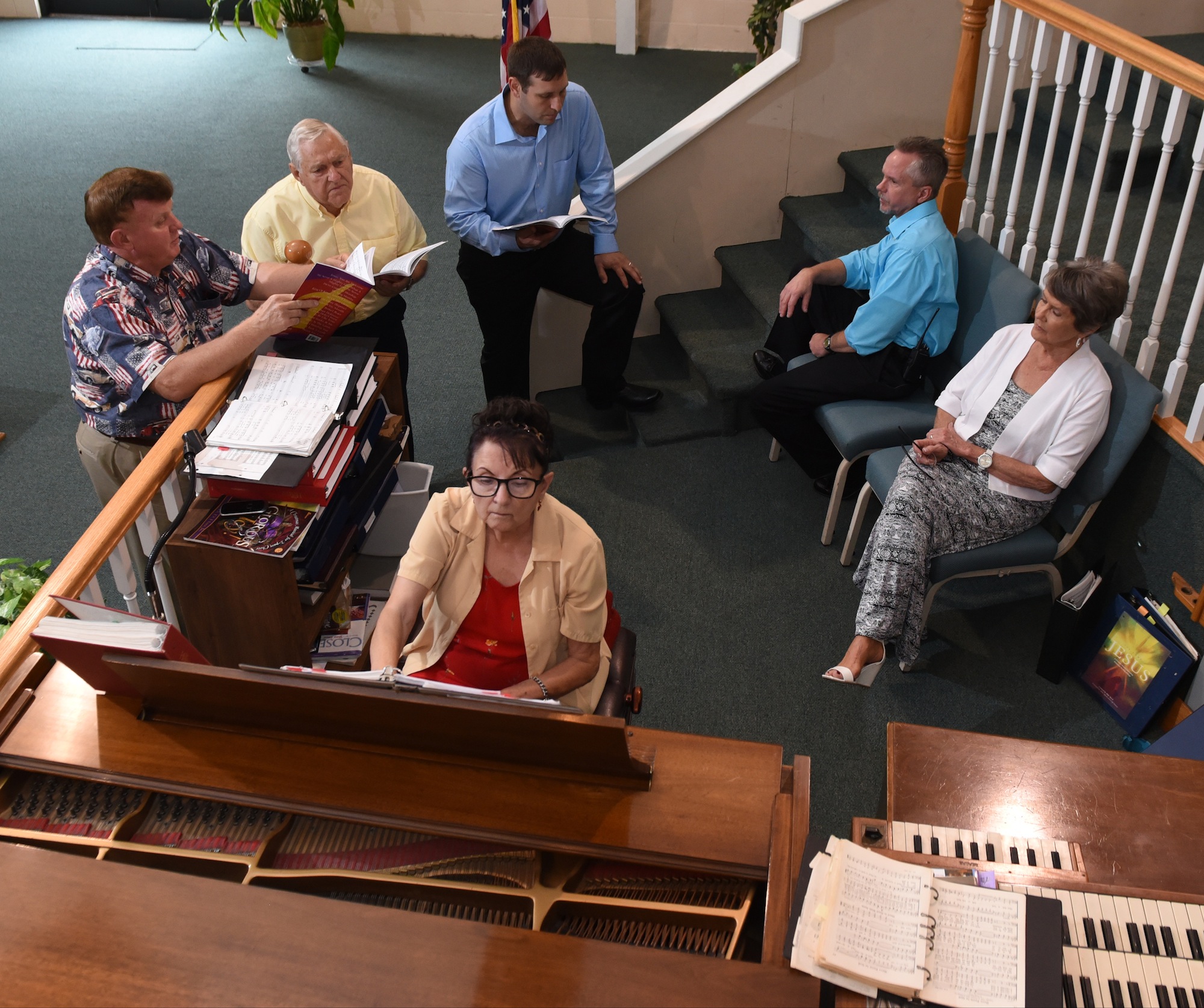 Choir members Dennis Bowman, Charlie Ramsey, Kevin Myers and Randy Lewis, back from left, rehearse with pianist June Edmondson. Una Atwood is seated right.