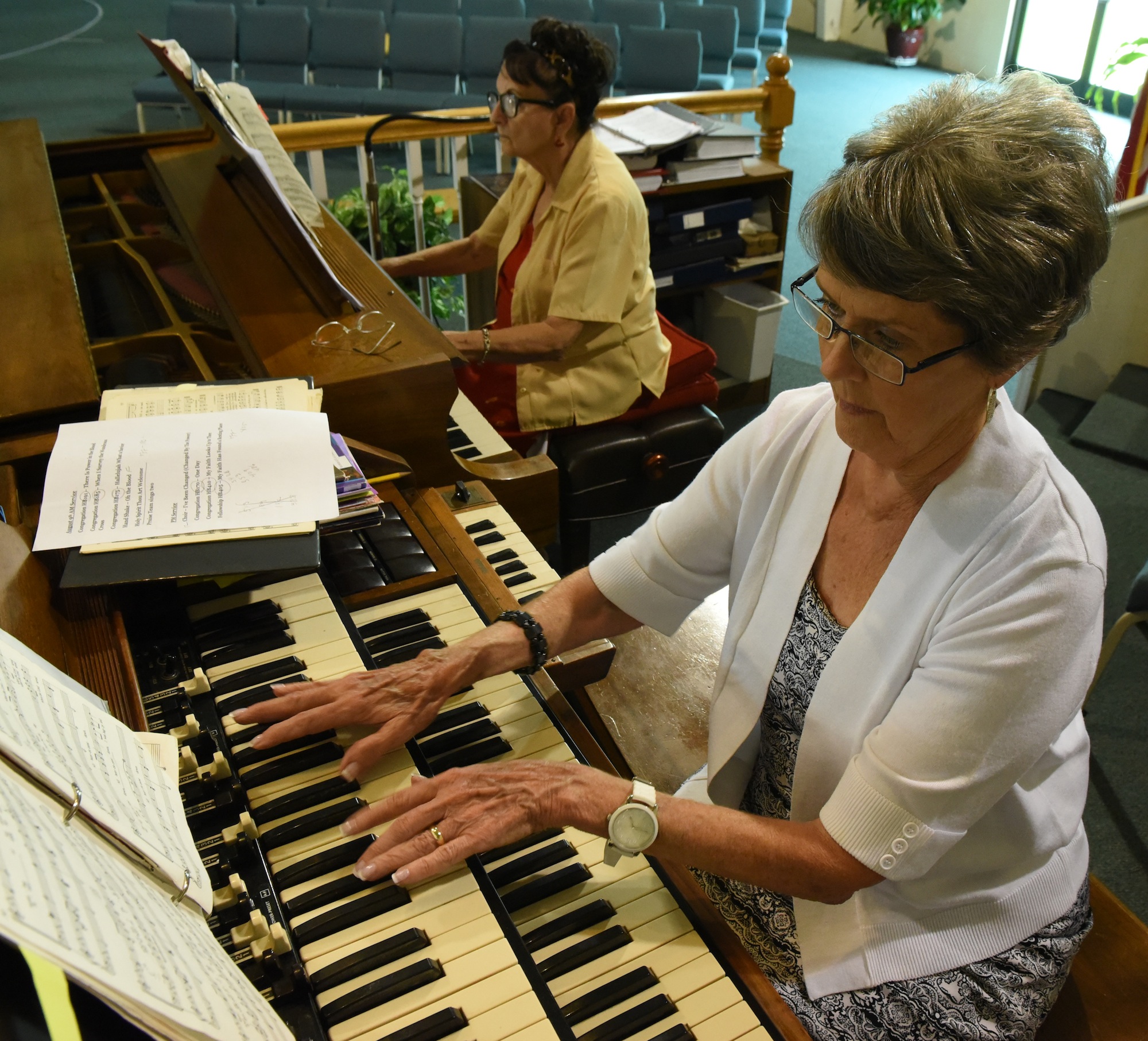 Pianist June Atwood, top, and organist Uma Atwood rehearse with the Westside Baptist choir.