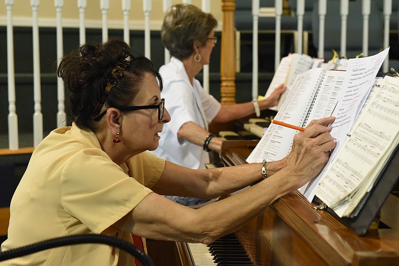 Pianist June Edmondson, foreground, and organist Una Atwood mark corrections in their scores during rehearsals at Westside Baptist Church in Rossville. Edmondson will mark her 60th anniversary as church pianist on Sept. 18; Atwood has been church organist for 48 of the 51 years she has been a member at Westside.