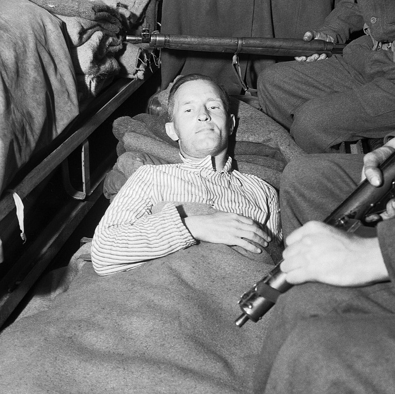 William "Lord Haw-Haw" Joyce is pictured in an ambulance under armed guard before being taken from British Second Army Headquarters to a hospital in 1945. Contributed photo