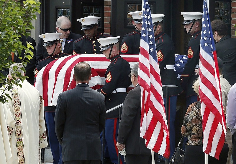 U.S. Marine pallbearers carry the casket with the remains of Marine Gunnery Sgt. Thomas Sullivan following his funeral service at Holy Cross Church in Springfield, Mass., Monday, July 27, 2015. Sullivan was one of five service members shot to death in the July 16 attack in Chattanooga. (AP Photo/Michael Dwyer)