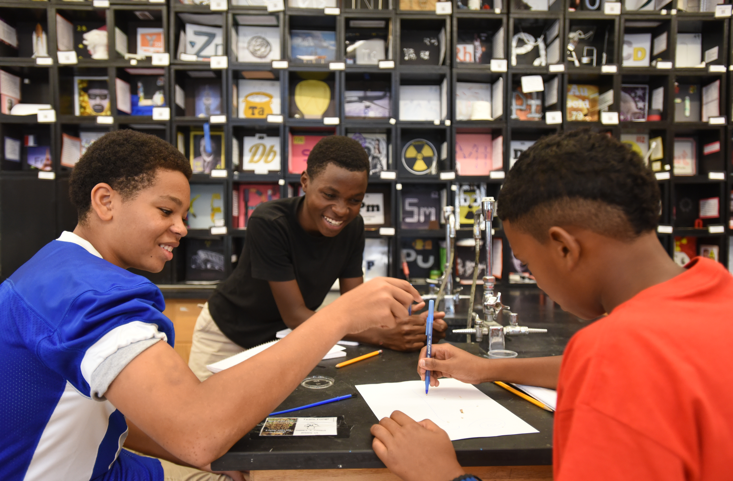 Ellington Love, Edimo Nintereste and Lerenzo Brock, from left, draw lines for a termite to follow in their 8th-grade science class Thursday, August 13, 2015 at Normal Park Upper School.