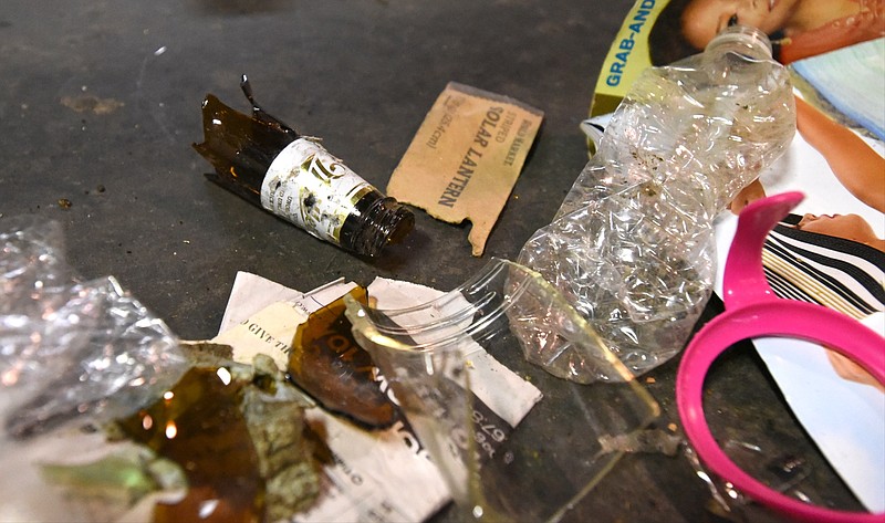 Broken glass is carried down the line Friday, August 7, 2015 at the John F. Germ Recycling Center. 