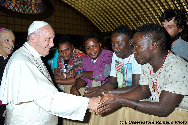 
              Pope Francis salutes migrants from Nigeria during his weekly general audience he held in the Pope Paul VI hall, at the Vatican,  Wednesday, Aug. 12, 2015. (L'Osservatore Romano/Pool Photo via AP)
            