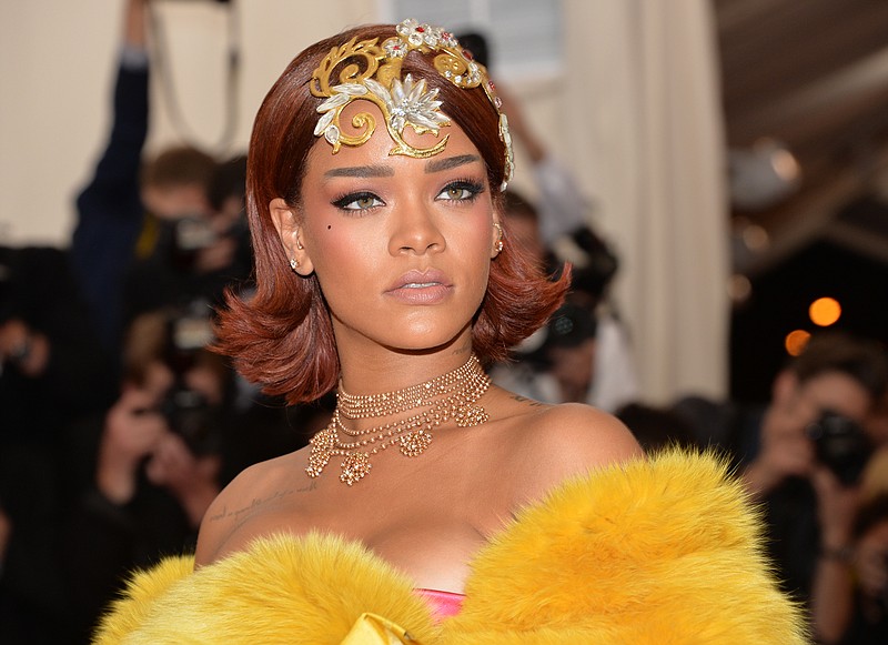 
              FILE - In this May 4, 2015 file photo, Rihanna arrives at The Metropolitan Museum of Art's Costume Institute benefit gala celebrating "China: Through the Looking Glass," in New York. Rihanna is headed to “The Voice.” NBC Entertainment Chairman Bob Greenblatt made the announcement Thursday, Aug. 13, 2015, that the singer will serve as a key adviser to all of the coaches on the new season of the singing competition show. (Photo by Evan Agostini/Invision/AP, File)
            