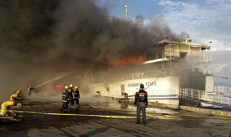 
              A fireman trains his hose at the burning MV Wonderful Stars ferry which caught fire at the port in Ormoc city in central Philippines early Saturday, Aug. 15, 2015. The inter-island ferry caught fire while it was docked and officials say all passengers have been safely evacuated. (AP Photo/John Kevin Pilapil)
            