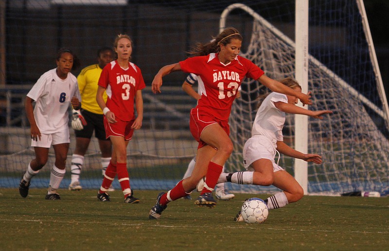 Baylor's Peyton Thomas, No. 13, and GPS's Izzy Phillips, No. 9, collide as they compete for the ball in this file photo.