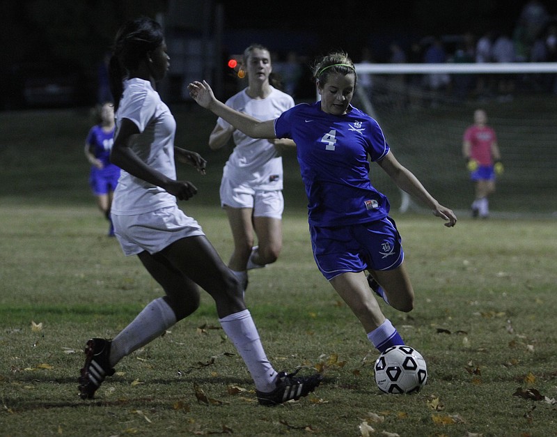 East Hamilton's Yinka Yadapo, No. 7, tries to intercept Boyd-Buchana's Allie Keasler, No. 4, before she can put the ball upfield in this file photo.