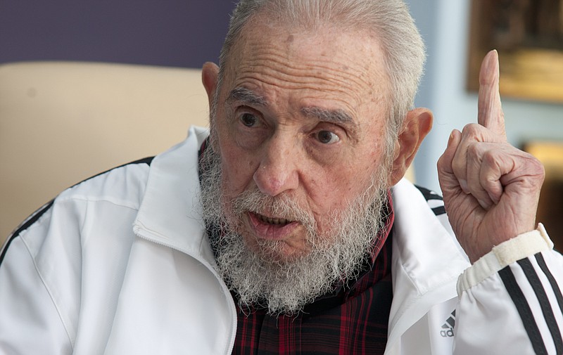 FILE - In this July 11, 2014 file photo, Cuba's Fidel Castro speaks with Russia's President Vladimir Putin in Havana, Cuba. Amid the excitement over the thaw in U.S.-Cuba relations, one person has been conspicuously absent: Fidel Castro. The former Cuban president hasnt made any public comment about the announcement that the U.S. and Cuba will restore diplomatic relations after more than 50 years of hostility.(AP Photo/Alex Castro, File)