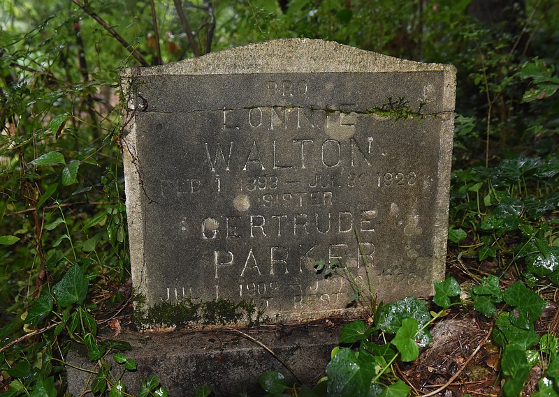 An old tombstone is seen at the site of an old cemetery located next to the construction site for a new housing development on Dartmouth Street in the North Chattanooga community Monday, Aug. 10, 2015, in Chattanooga, Tenn. 