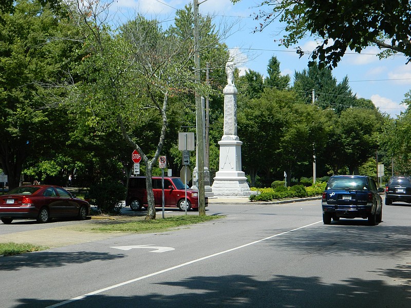 A vehicle sits in the Eighth Street crossing of Ocoee Street, waiting for northbound traffic to pass. Proposed safety changes call for removing the Ocoee Street northbound left-turn-only lane, which feeds traffic into the crossing zone, located near a pair of Cleveland's monuments.