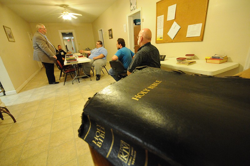 Jon Rector, standing left, talks with others at the Union Gospel Mission in this file photo.