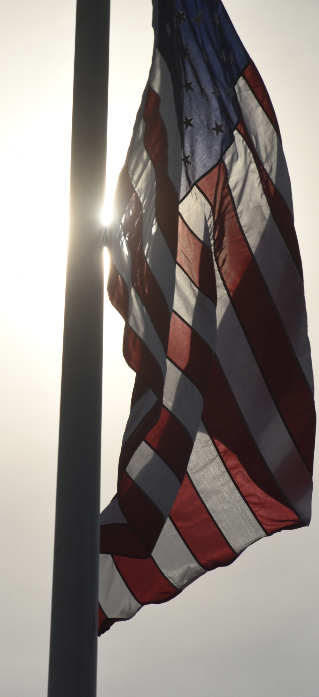 An American flag is raised to full staff at the conclusion of an opening ceremony Sunday, Aug. 16, 2015, in Chattanooga, Tenn., for a memorial to the five servicemen who were killed on July 16. The memorial is located at 6219 Lee Highway near the Armed Forces Career Center where the July attack began.