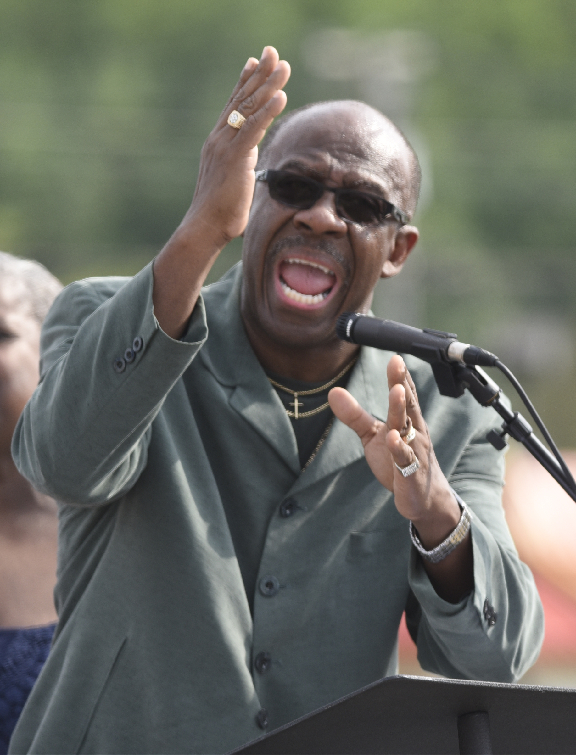 Rev. Willie Kitchens sings "People Get Ready" during an opening ceremony Sunday, Aug. 16, 2015, in Chattanooga at a memorial to the five servicemen who were killed on July 16. The memorial is located at 6219 Lee Highway near the Armed Forces Career Center where the July attack began.