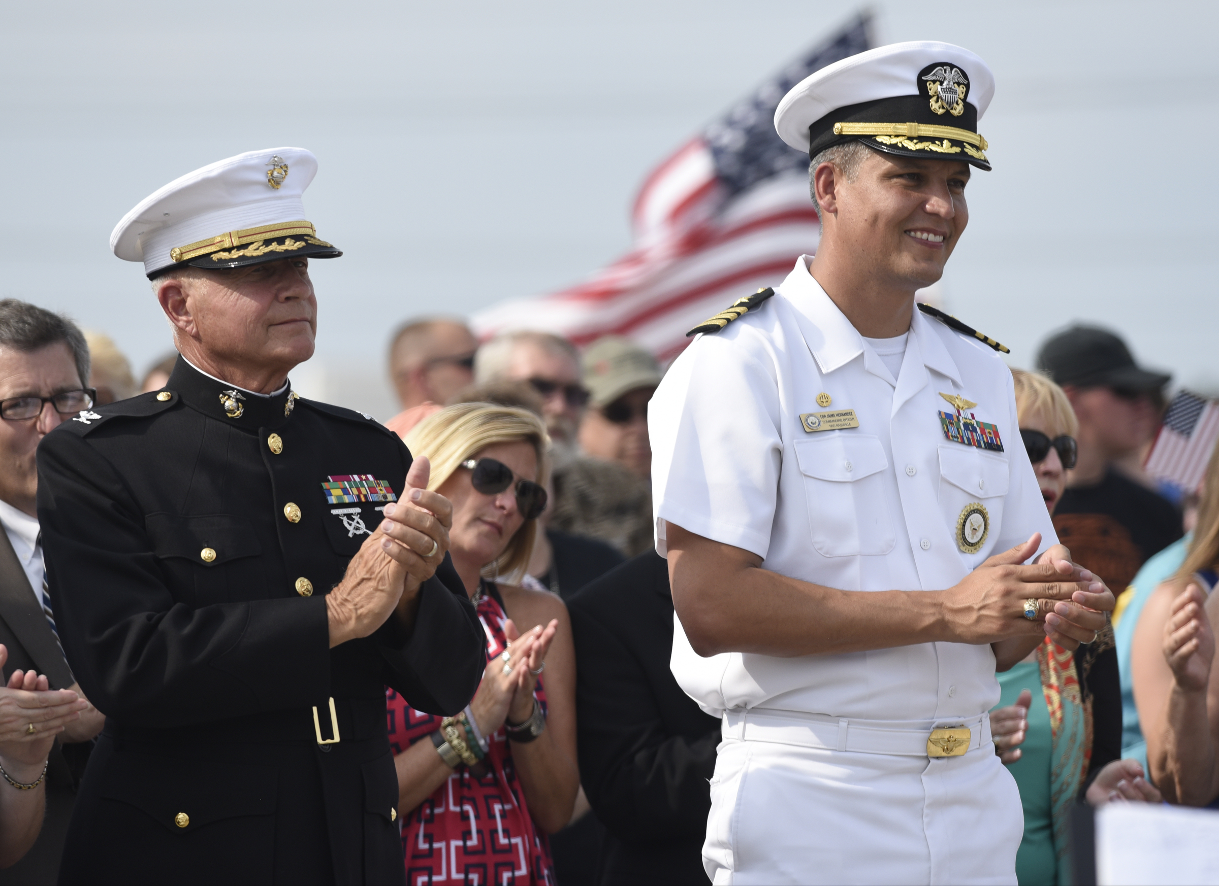 U. S. Marine Col. Wayne A. Rich, Jr., left, and U. S. Navy Cdr. Jaime Hernandez clap during an opening ceremony Sunday, Aug. 16, 2015, in Chattanooga, Tenn., at a memorial to the five servicemen who were killed on July 16. The memorial is located at 6219 Lee Highway near the Armed Forces Career Center where the July attack began.