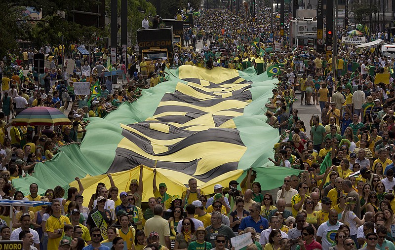 
              Demonstrators shout anti-government slogans as they march holding a giant flag with the word "Impeachment" written on it, during a protest demanding the impeachment of Brazil's President Dilma Rousseff in Sao Paulo, Brazil, Sunday, Aug. 16, 2015. Demonstrations are taking place across Brazil against President Rousseff, whose popularity has never been lower as she faces a sputtering economy and a massive corruption scandal. (AP Photo/Andre Penner)
            