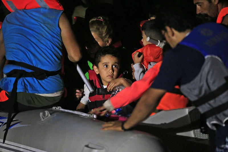 
              Migrants mostly from Iran, including children, start their journey on a dinghy from the coastal town of Bodrum, Turkey, to the nearby Greek island of Kos, early Sunday, Aug. 16, 2015. With the shores of Kos - a gateway to Europe - just a few kilometers (miles) away, hundreds of migrants are piling into tiny inflatable dinghies each night and attempting to make the crossing powered by tiny outboard motors and plastic paddles. (AP Photo/Lefteris Pitarakis)
            