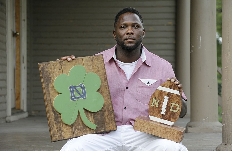 
              In this Aug. 14, 2015 photo, Larry Stephney holds wooden products he helped make while he was an inmate at a privately run prison in Nashville, Tenn. Stephney says inmates were required to build plaques, birdhouses, dog beds and cornhole games for officials who sold the items through an online business and at a local flea market. (AP Photo/Mark Humphrey)
            