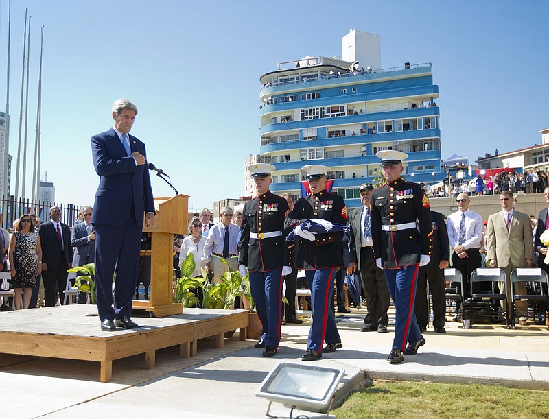 Secretary of State John Kerry watches as U.S. Marines carry the American flag during its raising over the newly reopened embassy last week in Havana, Cuba.