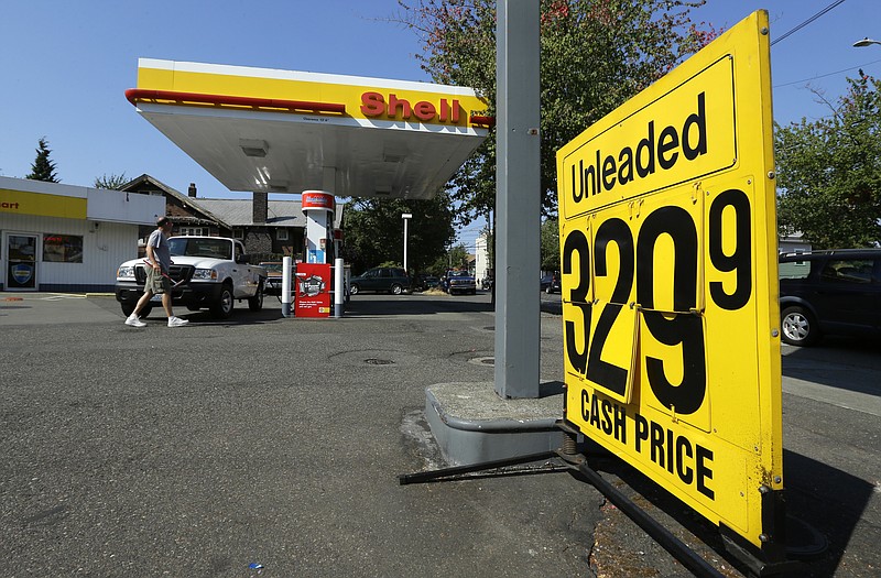 
              In this Aug. 13, 2015 photo, the cash price for gasoline is shown on a changeable sign at a gas station in Seattle. Washington state recently approved a 16-year, $16 billion transportation plan that raises fuel taxes, vehicle fees and bonding. (AP Photo/Ted S. Warren)
            