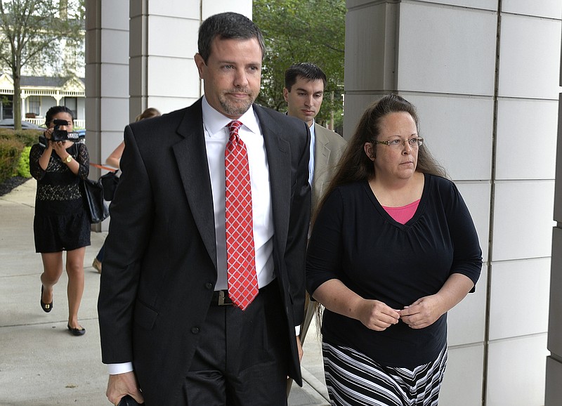 In this July 20, 2015, file photo, Rowan County Clerk Kim Davis, right, walks with her attorney Roger Gannam into the United States District Court for the Eastern District of Kentucky in Covington, Ky.