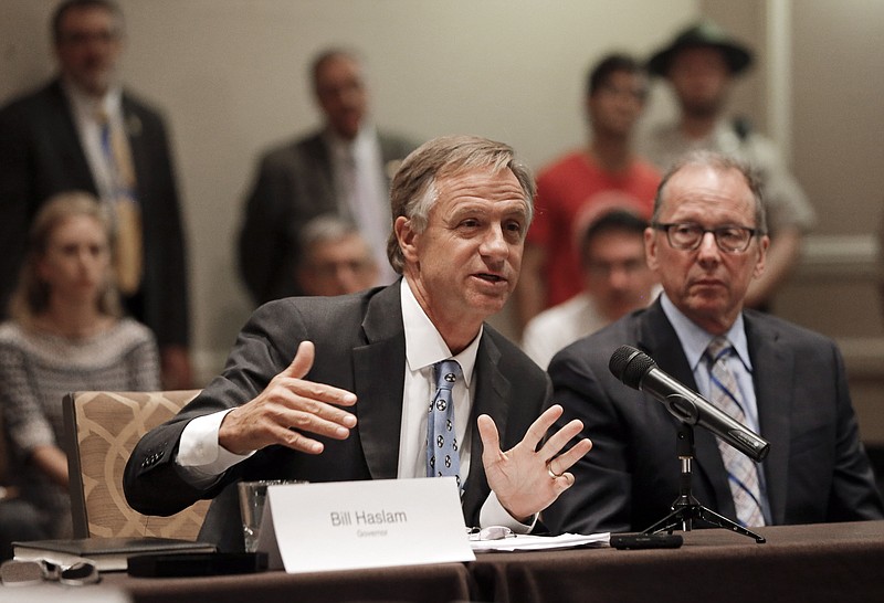 In this Aug. 13, 2015, file photo, Tennessee Gov. Bill Haslam, left, speaks during a meeting of his 15-stop transportation funding tour in Nashville.