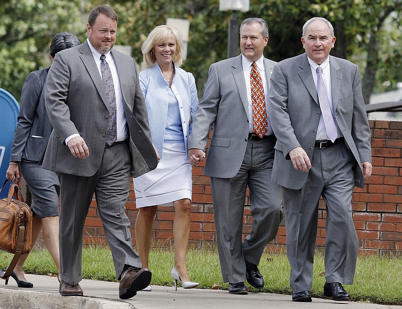Mike Hubbard walks to the Lee County Justice Center holding hands with his wife Susan, Monday, Aug. 17, 2015, in Opelika, Ala. Also pictured are his lead attorney Mark White, right, Lance Ball, left, and Augusta Dowd, back.