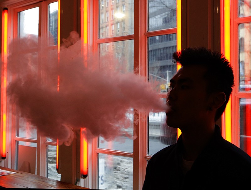 
              FILE - In this Feb. 20, 2014 file photo, a man exhales vapor from an e-cigarette in New York. A study at 10 Los Angeles high schools links e-cigarettes with later tobacco use. The government-funded study was published in Tuesday, Aug. 18, 2015 in the Journal of the American Medical Association. It doesn't prove that electronic cigarettes are a "gateway drug" but some doctors say it bolsters arguments that the devices need to be strictly regulated. (AP Photo/Frank Franklin II)
            