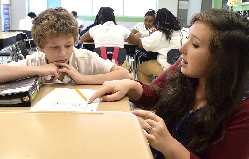 Sixth grade reading and language arts teacher Kristen Heath helps Jackie Mabe with his writing assignment. Dalewood Middle School is one of several iZone schools in the Hamilton County System that is working to improve test scores.