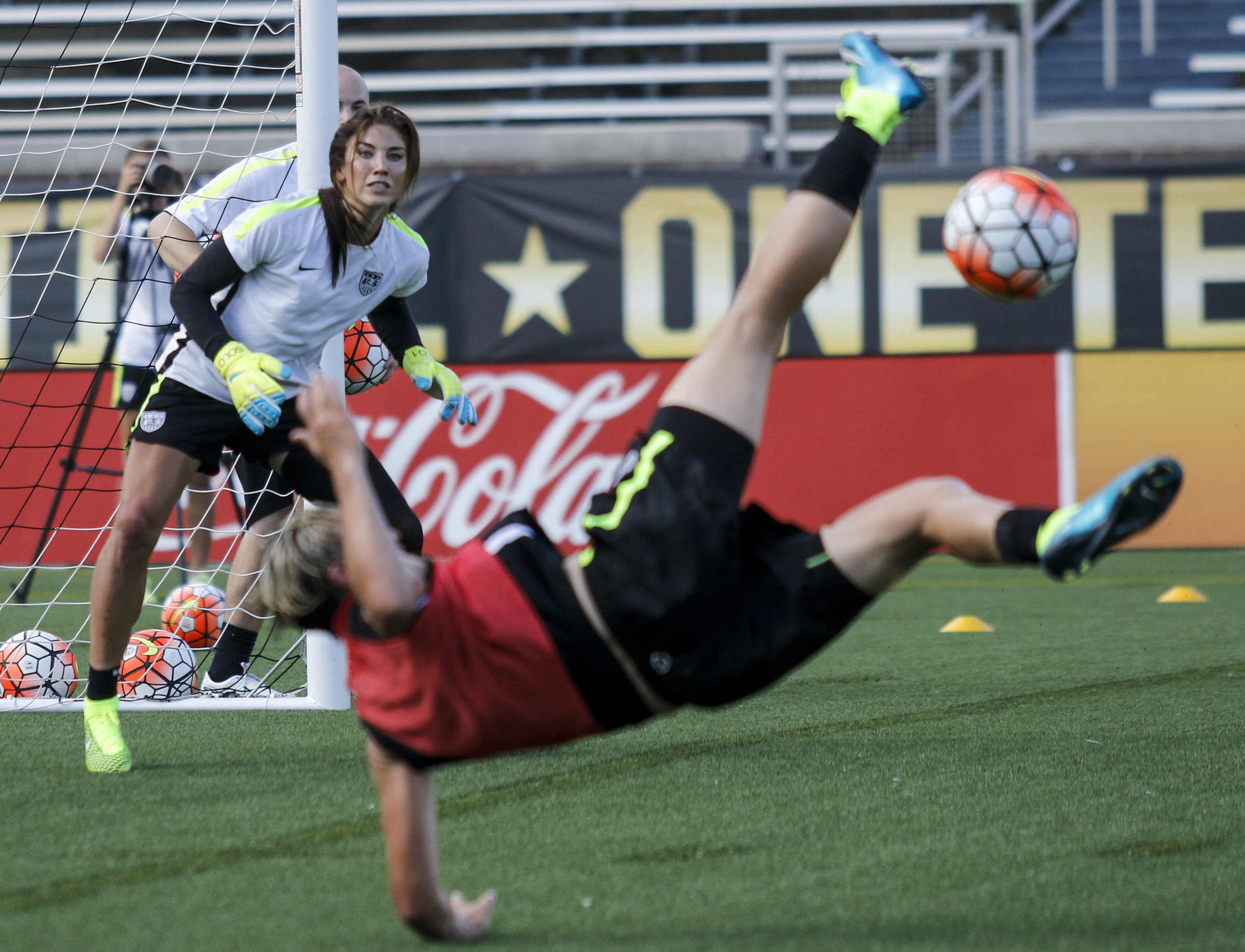 U.S. Women's National Soccer Team goalkeeper Hope Solo, left, watches as teammate Abby Wambach tries to bicycle kick the ball into the goal during practice at Finley Stadium on Tuesday, Aug. 18, 2015, in Chattanooga, Tenn. The team plays Costa Rica on Wednesday at Finley Stadium.